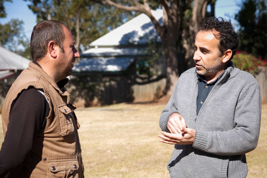 Mr Ezidkhalo speaks with an Ezidi man in Toowoomba.