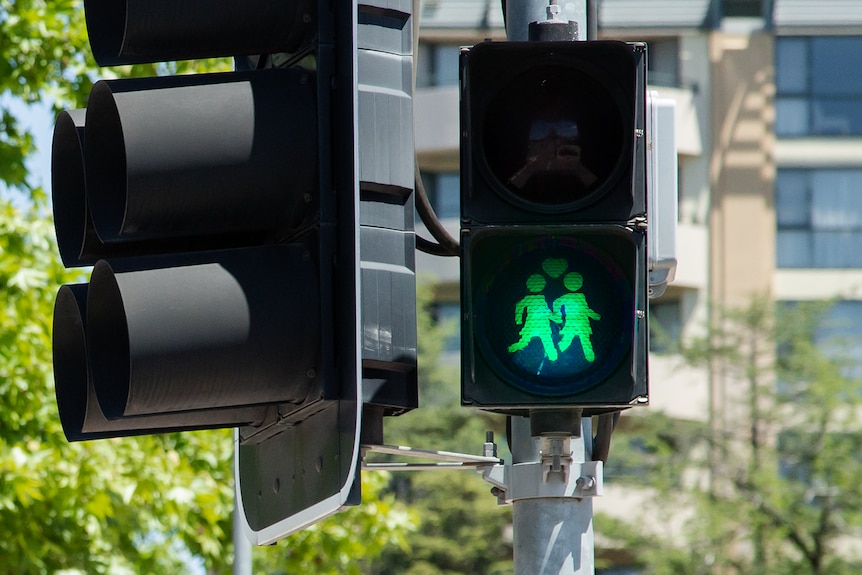 A same-sex female couple on a Canberra pedestrian light