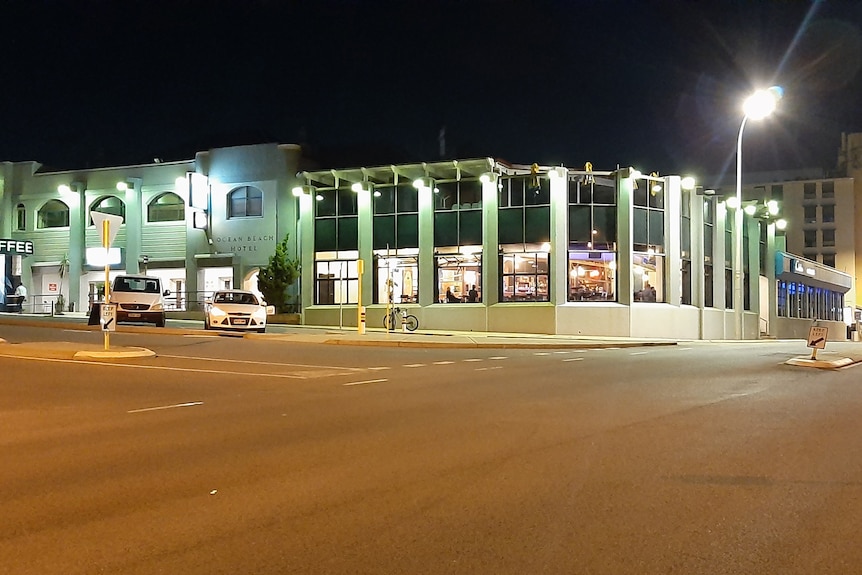 A wide shot at night of the Ocean Beach Hotel in Cottesloe.