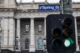 Victorian Parliament with Spring St sign and green traffic light in foreground
