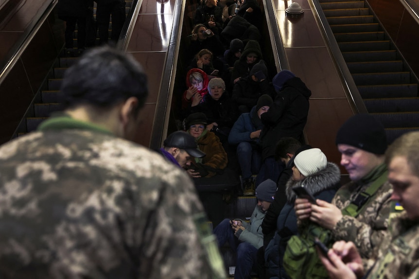 People take shelter inside the metro station.