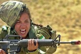 An Israeli army female soldier shouts while holding a M16 rifle on May 23, 2005.