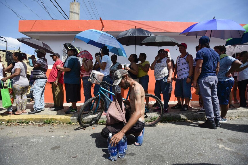 People affected by Hurricane Maria wait in line at Barrio Obrero to receive supplies