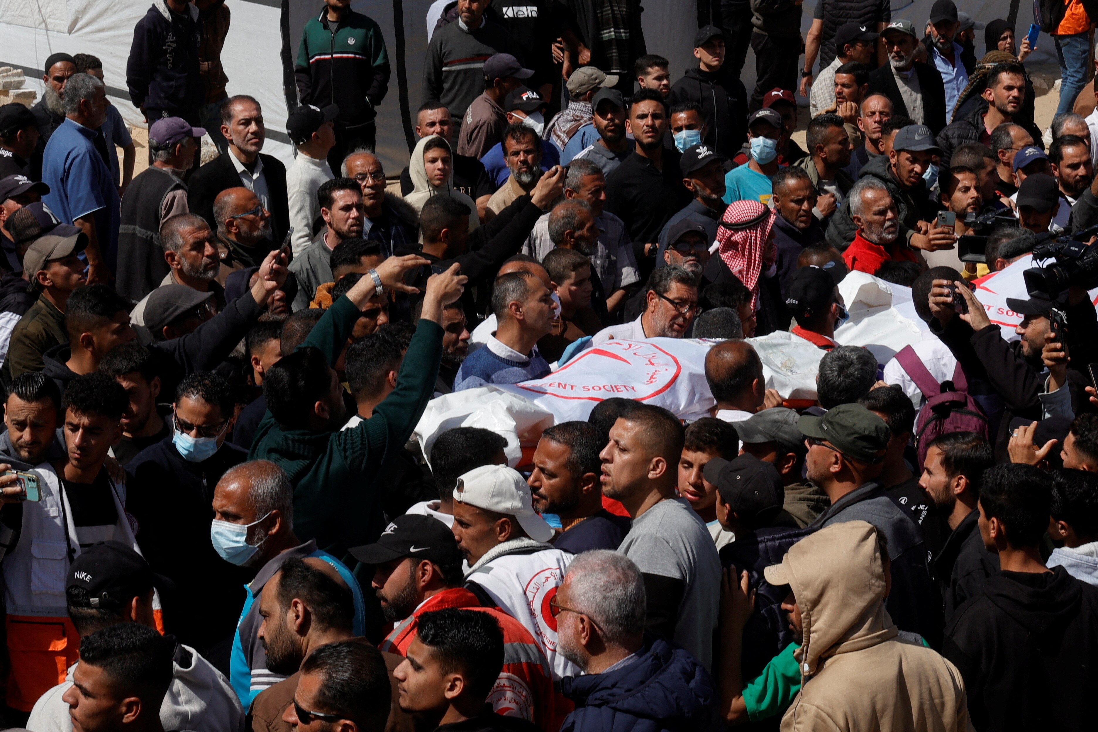 Crowds gather for a funeral