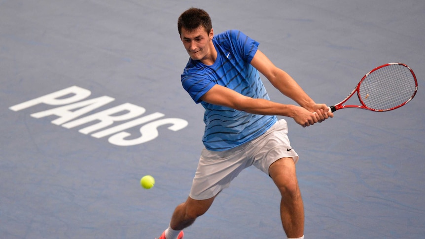 Bernard Tomic returns a shot against Feliciano Lopez