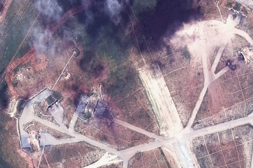 A satellite image shows plumes of black smoke rising from the Shayrat military base in Syria.