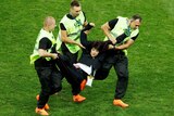 Stewards grab a pitch invader during the World Cup final.