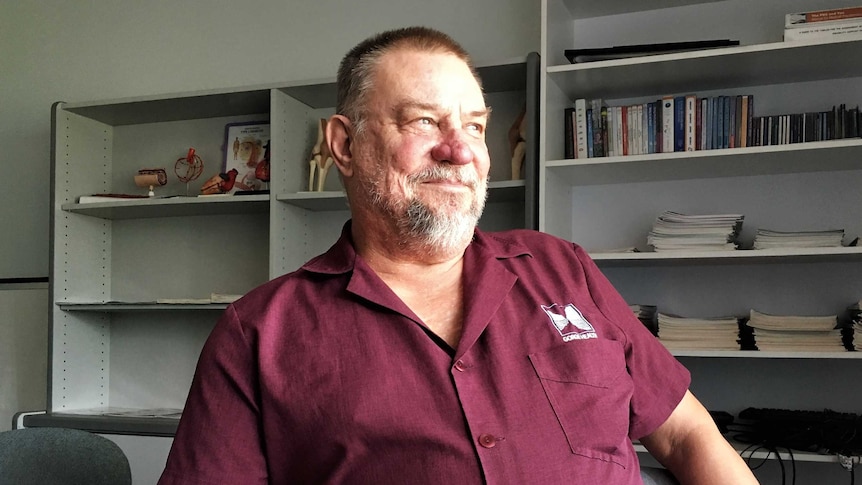 Dr Peter Spafford looking out the window while sitting in his surgery of Gorge Health in Katherine