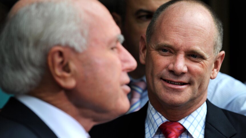 Campbell Newman looks at John Howard as he speaks while campaigning at The Gap.