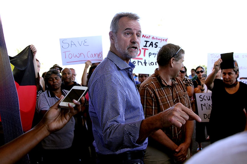 Nigel Scullion faces protesters