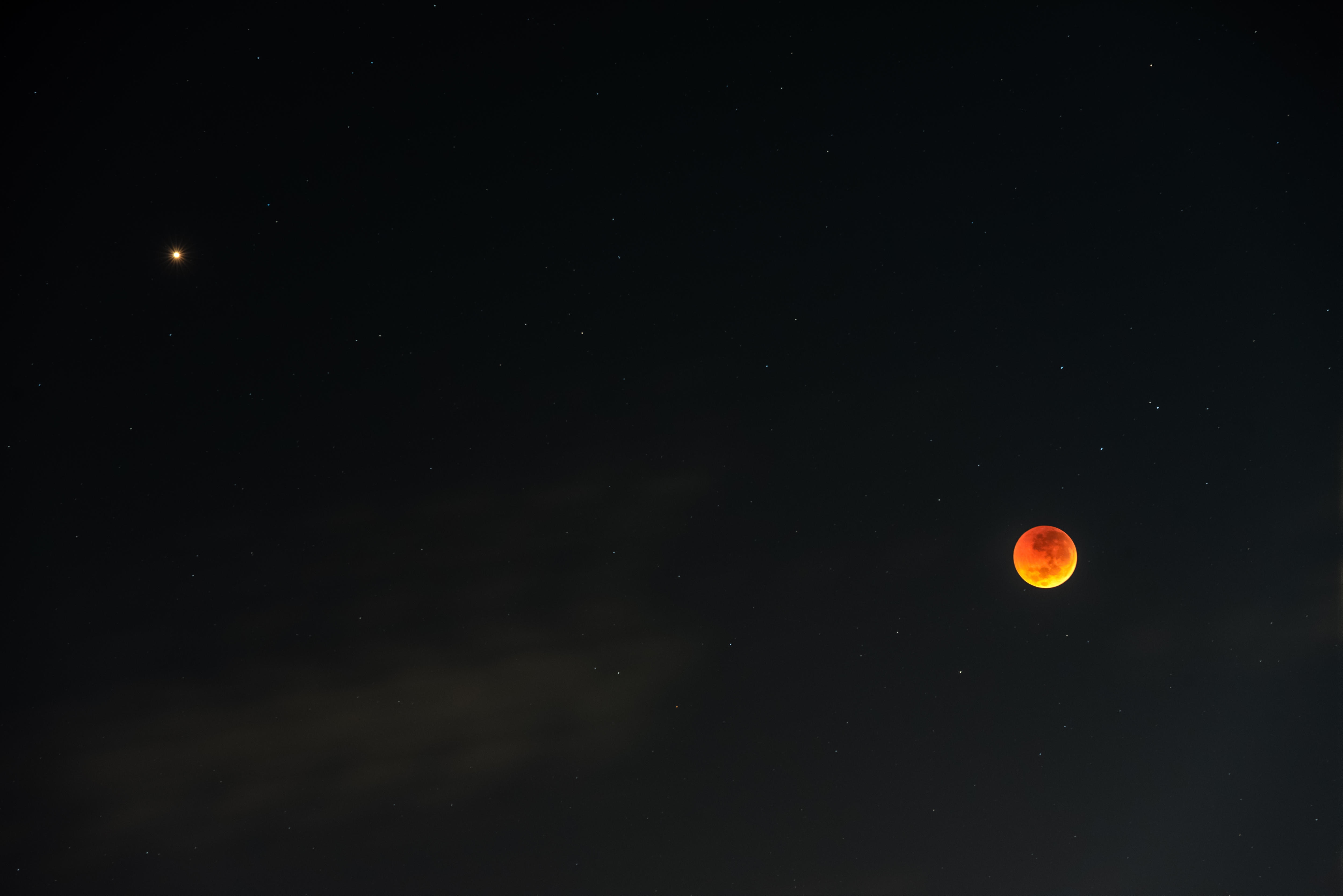 A tiny red dot on the left of the black image