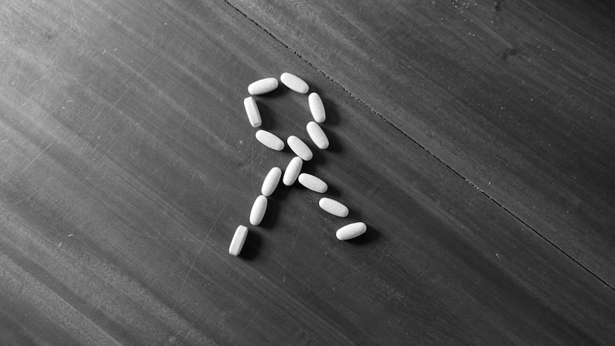 A HIV white ribbon made out of white tablets