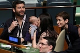 New Zealand Prime Minister Jacinda Ardern kisses her baby Neve at the UN on September 24, 2018.