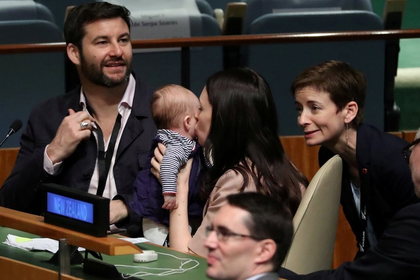 Jacinda Ardern kisses her baby before speaking at the Nelson Mandela Peace Summit.