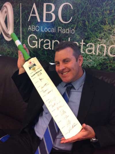 Grandstand's Craig Norenbergs with the signed Cricket Australia bat