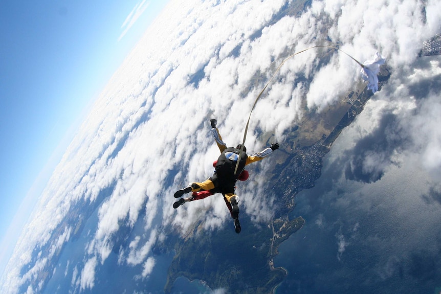 Two skydivers jumping out of an aeroplane.