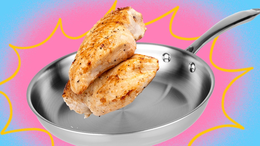 Two pieces of fried chicken are seen hovering over a clean stainless steel frying pan cut out against a pink and blue backdrop.