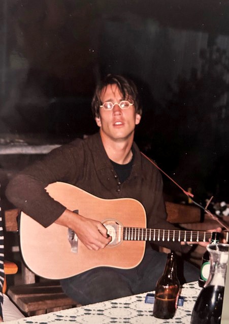 Old photo of man playing guitar