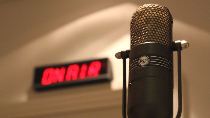 An old style microphone with an 'On-Air' light in the background, 3 October 2008.