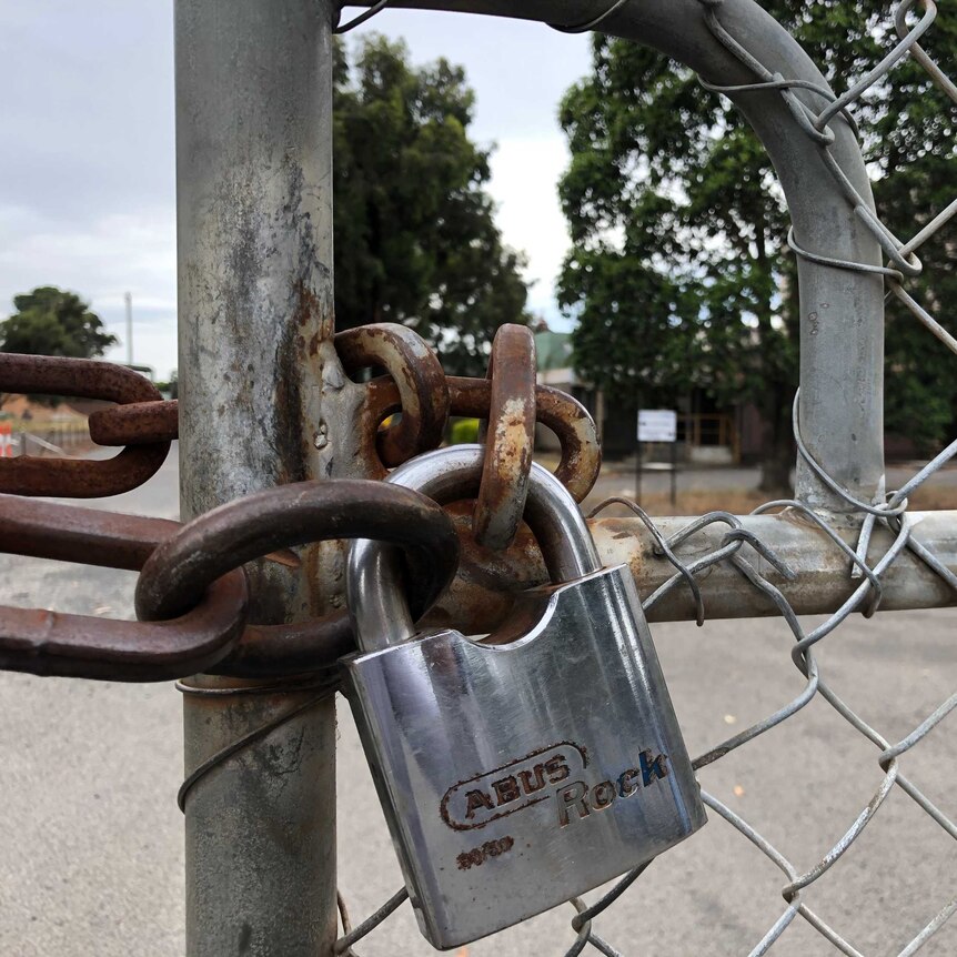 A rusty lock and chain on a gate at Steelvision's Morwell factory