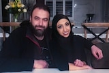 Zain Tiba with his arm around his daughter Ella Tiba at the kitchen table in their home. 