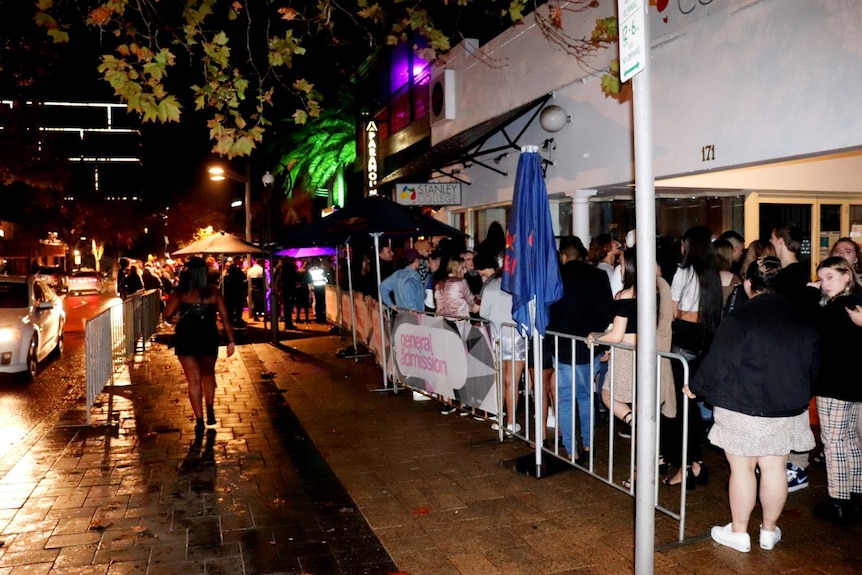 A queue of people line up along a barricade outside a nightclub in Northbridge, in Perth's centre.