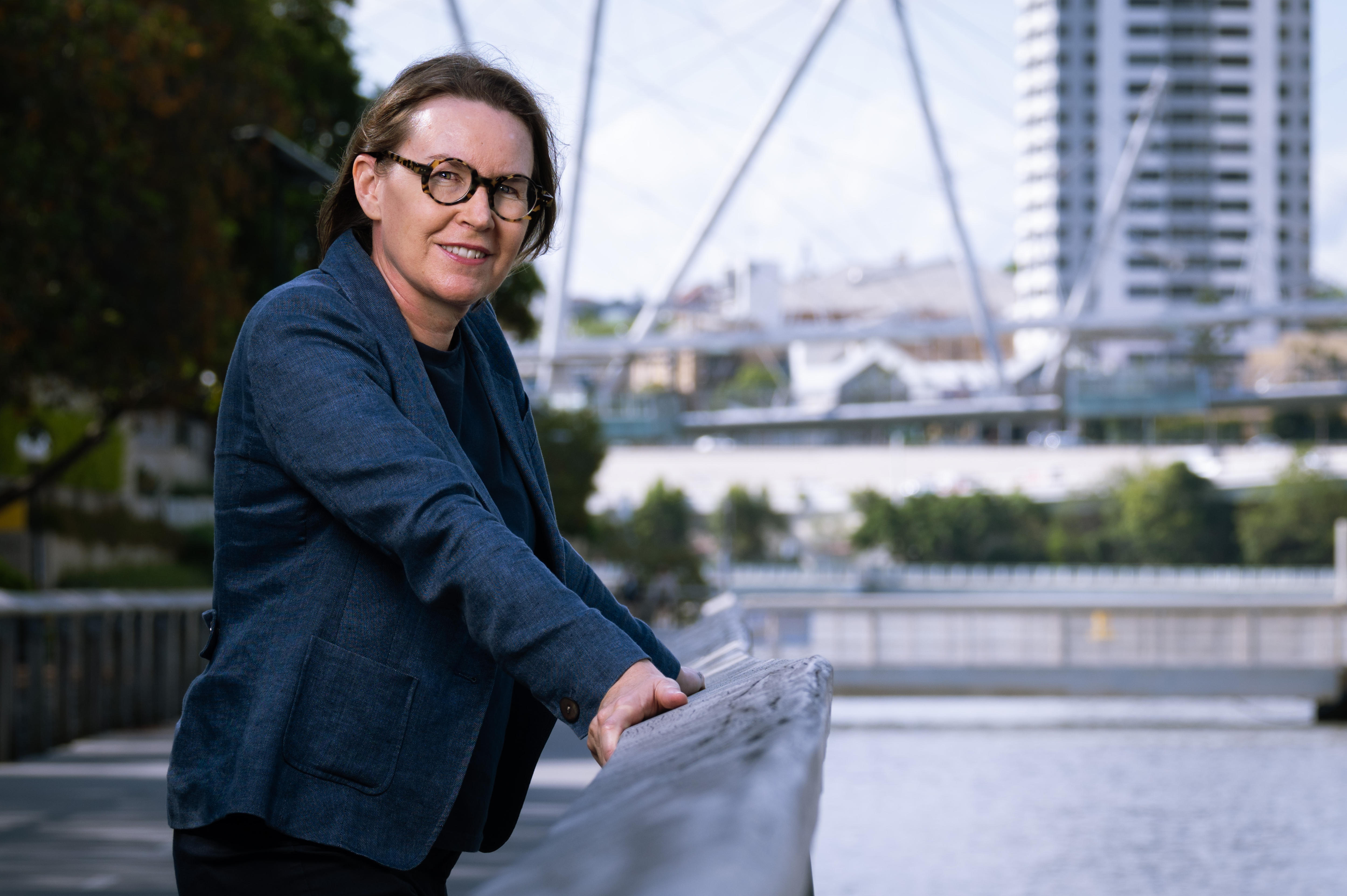 A woman on a riverside promenade