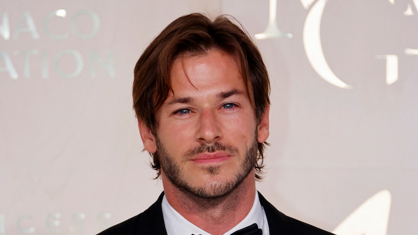 Gaspard Ulliel poses on the red carpet.