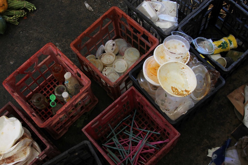 An aerial shot of different types of dirtied plastics sorted into milk crates.