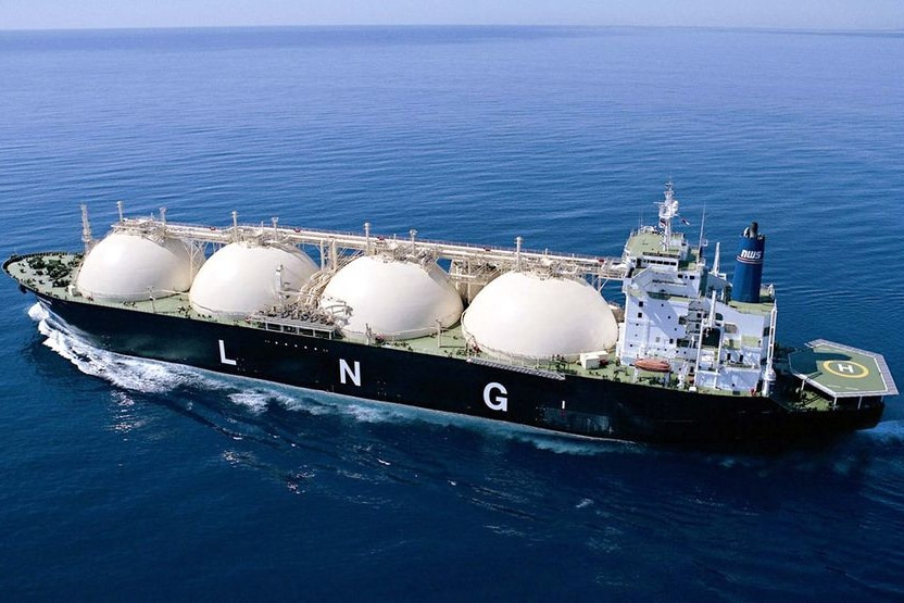 Aerial shot of an LNG ship sailing in a deep blue ocean off the coast of Western Australia