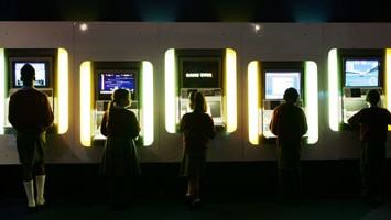 School children play arcade games at the Game On exhibition in London.