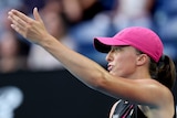 Iga Swiatek gestures with her left hand during an Australian Open match.