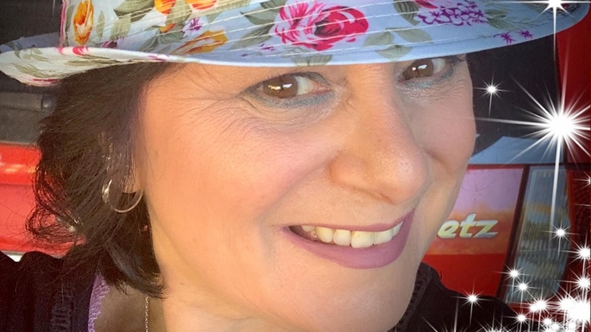 A woman wearing a floral hat.