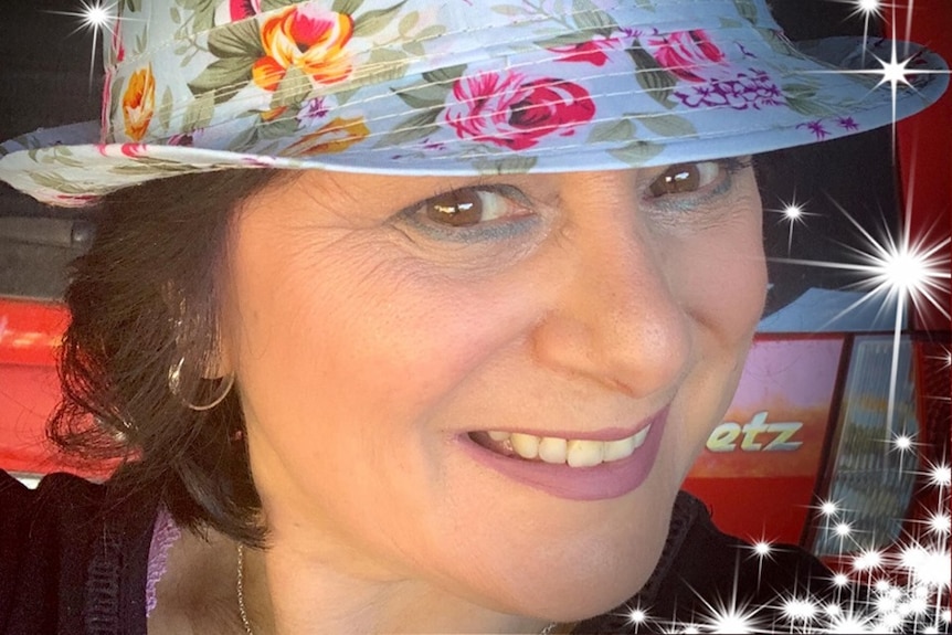 A woman wearing a floral hat.