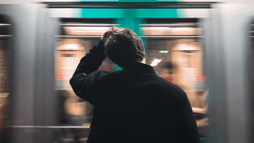 Standing in front of train