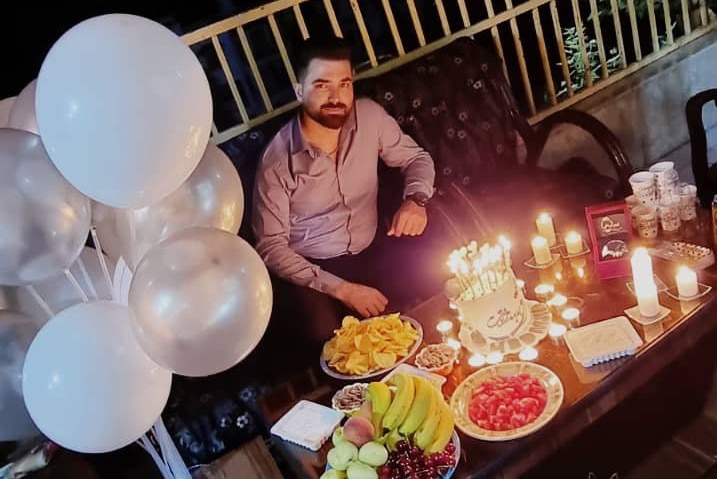a young man celebrating his birthday with cake and candles