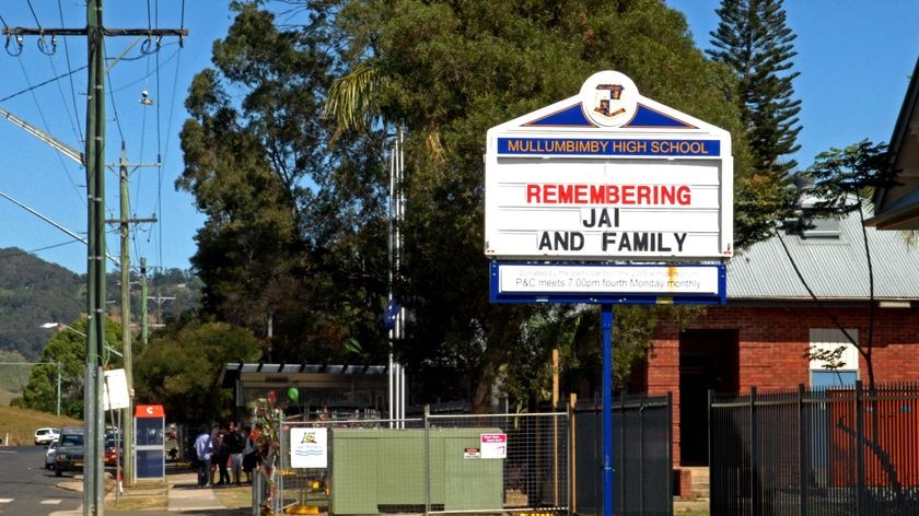 A condolence message sits on a board outside Mullumbimby High School.
