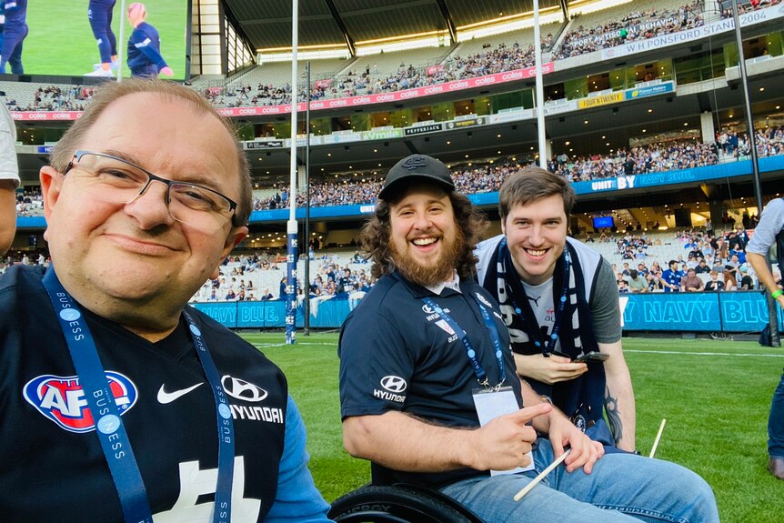Two men in wheelchairs and a friend on ground at the G