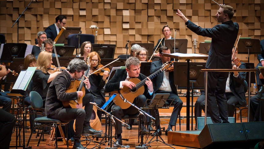Slava and Leonard Grigoryan on stage with the Tasmanian Symphony Orchestra