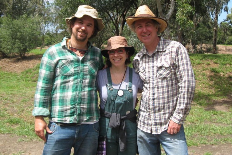 Ben Goodes, Louise Dorrat and Doug Fargher outside wearing hats