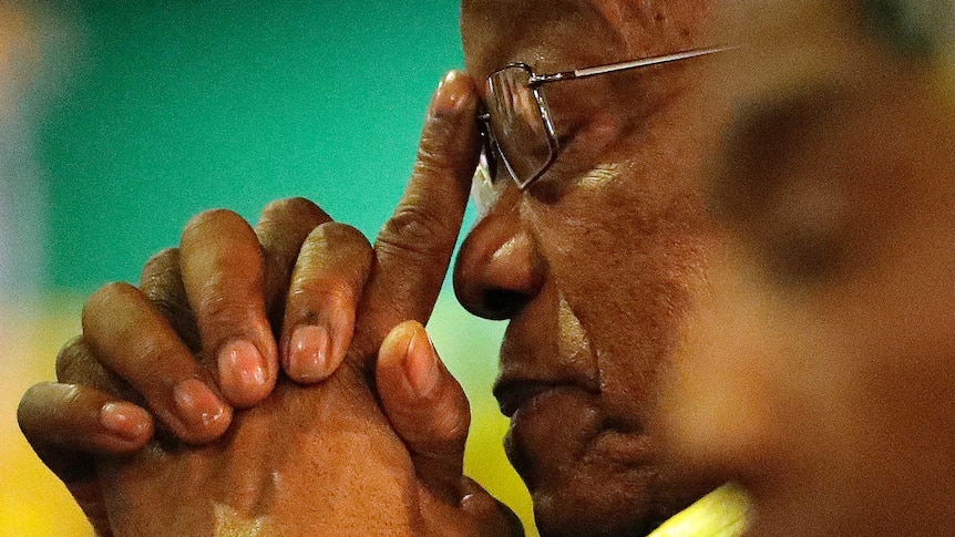 Jacob Zuma rests his head in his hands as he attends the African National Congress elective conference