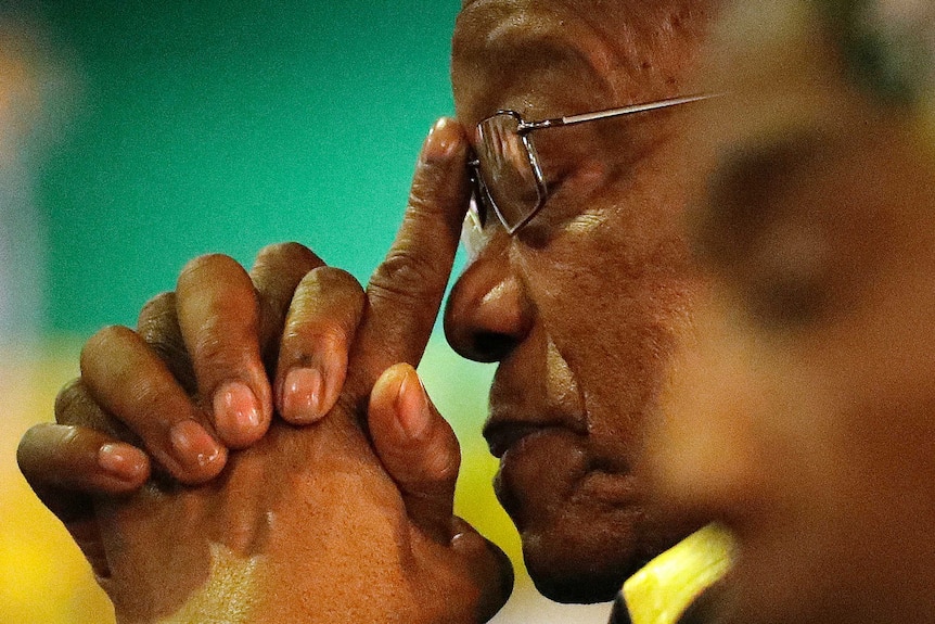 Jacob Zuma rests his head in his hands as he attends the African National Congress elective conference