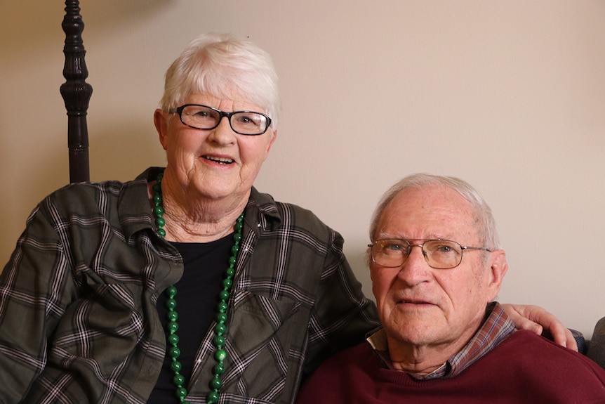 Penny Powers and her husband Barry smiling.