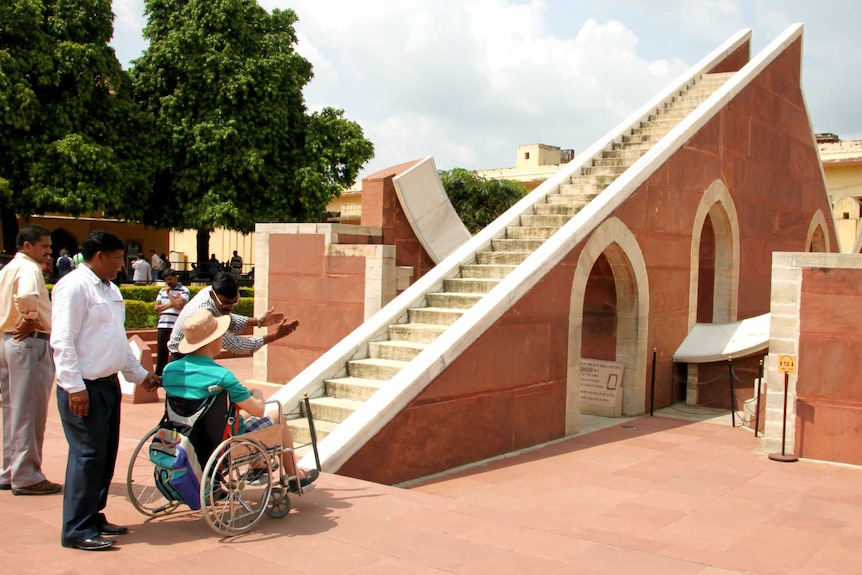 Martin in a wheelchair in front of an impossible staircase.