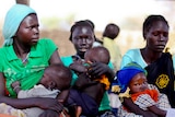 Women sit in a queue in Doro refugee camp.