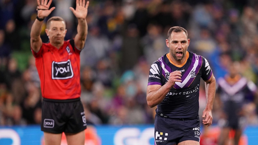 The referee signals for a sin binning as Cameron Smith jogs off the field