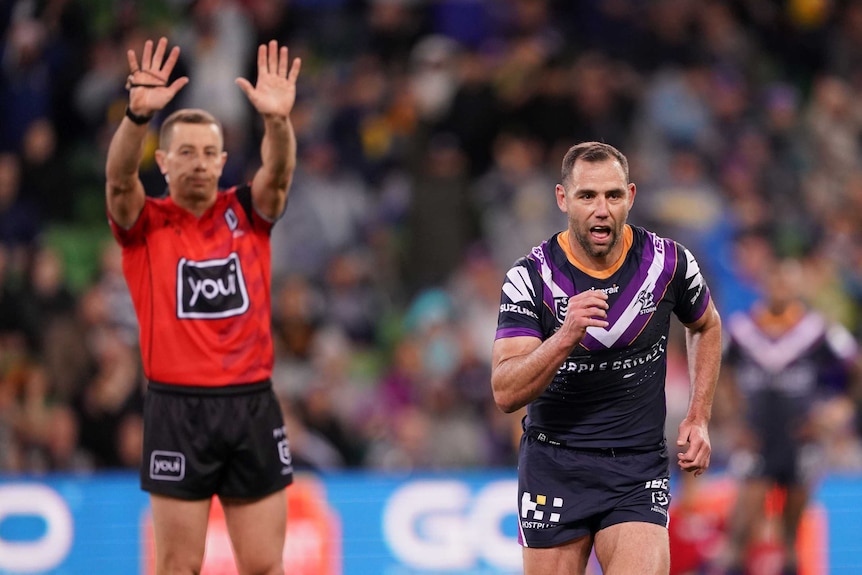 The referee signals for a sin binning as Cameron Smith jogs off the field