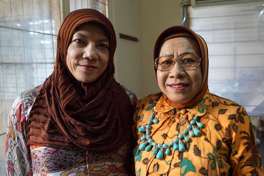 An Indonesian transgender woman, and a man transitioning to a transgender woman, both wearing hijabs.