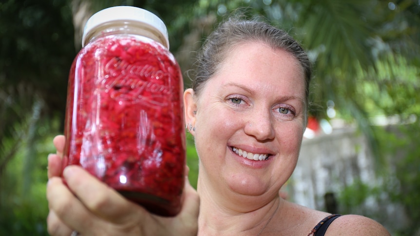 Jean Martinez holds a jar of sauerkraut
