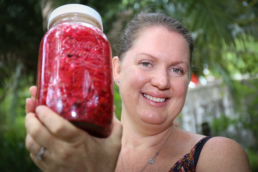 Jean Martinez holds a jar of sauerkraut